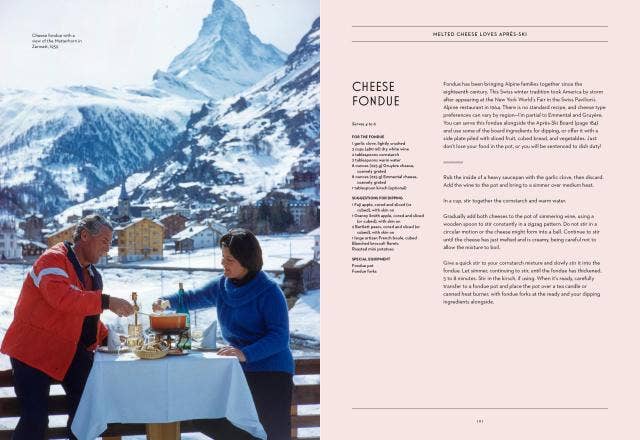 Two people enjoying cheese fondue in a snowy mountain village setting.