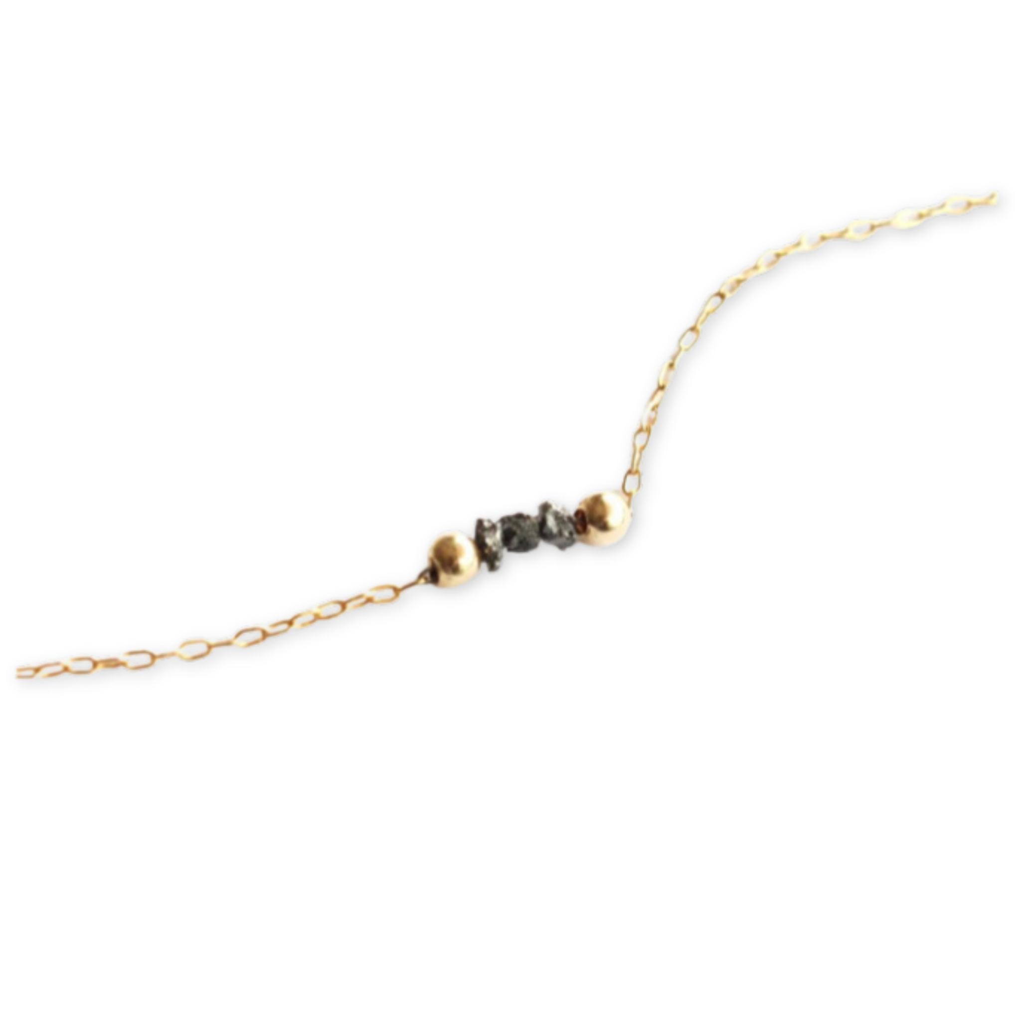 gold chain with two gold beads and three rough black diamonds