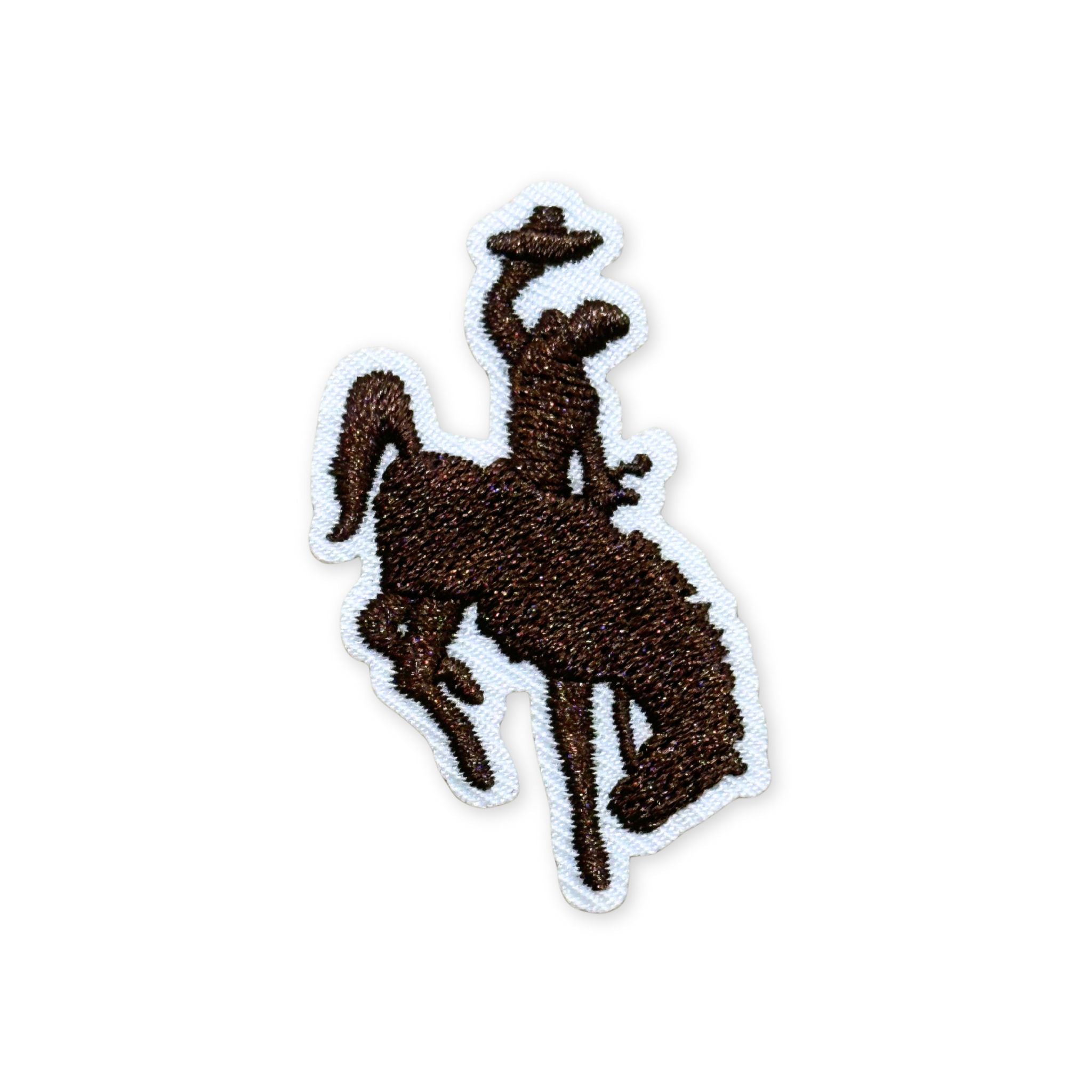 Embroidered patch, showing the silhouette of a bucking bronco and cowboy in brown stitching and white boarder.