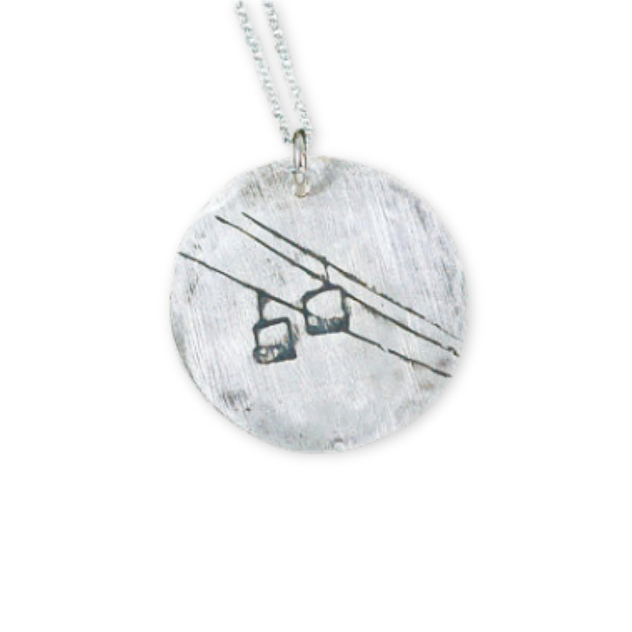 silver pendant with a chairlift design on it