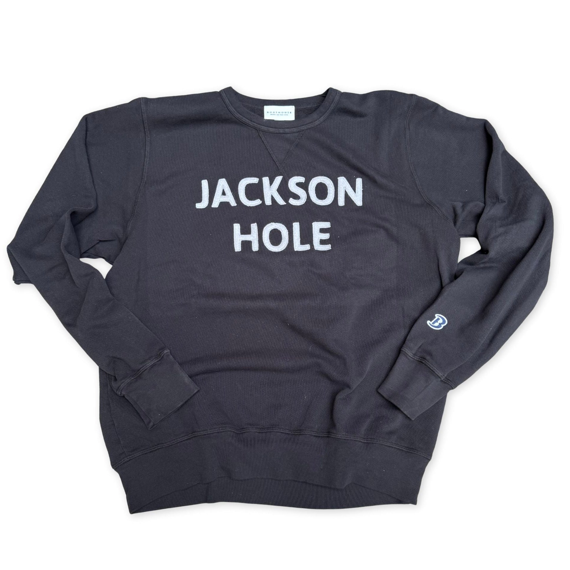 Navy blue sweatshirt with 'Jackson Hole' text on a white background