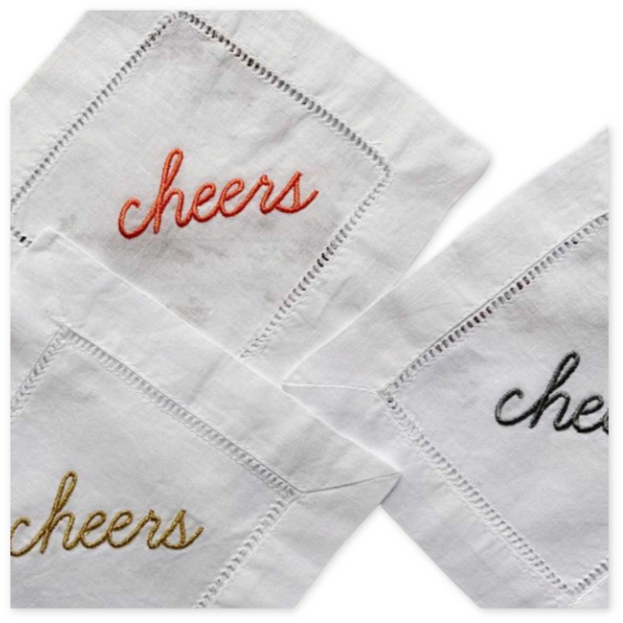 set of four cotton and linen blend cocktail napkins with the embroidered word cheers