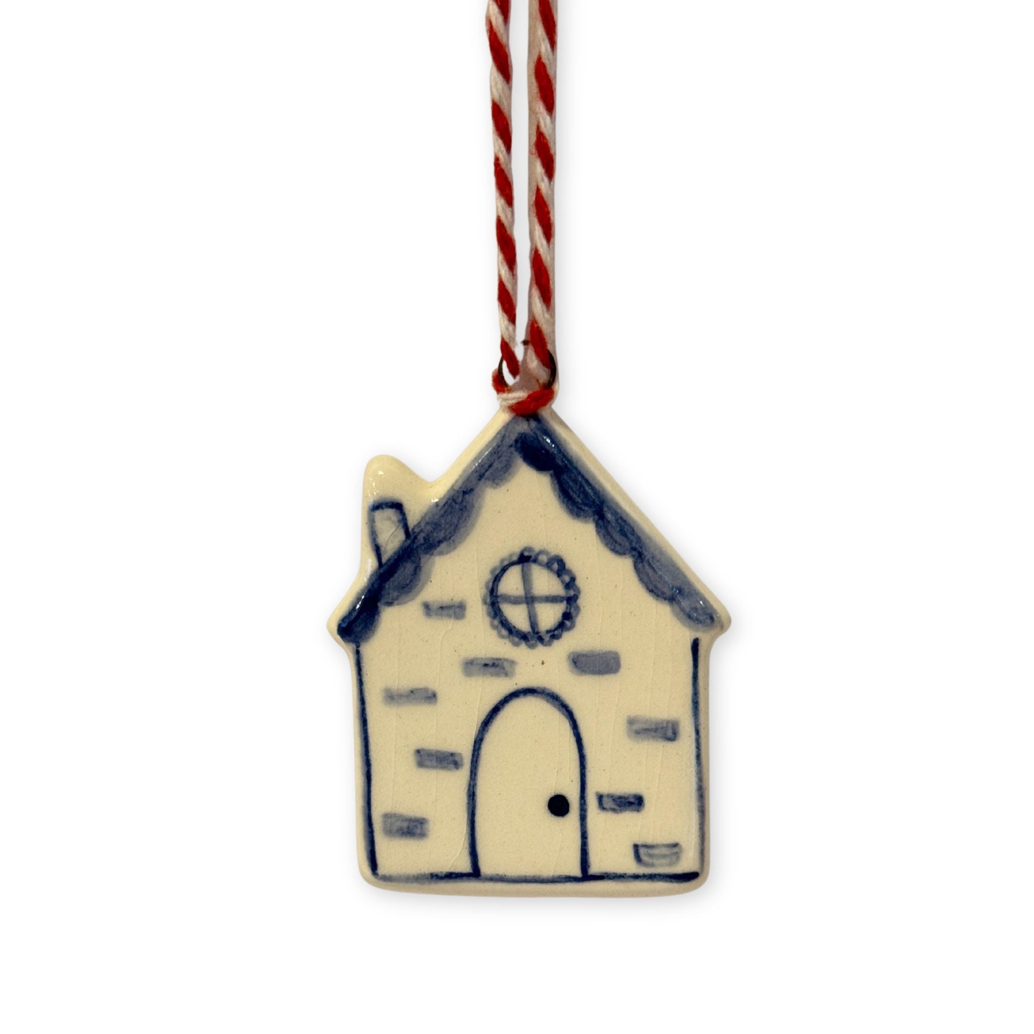 Decorative house ornament with blue accents on a white background