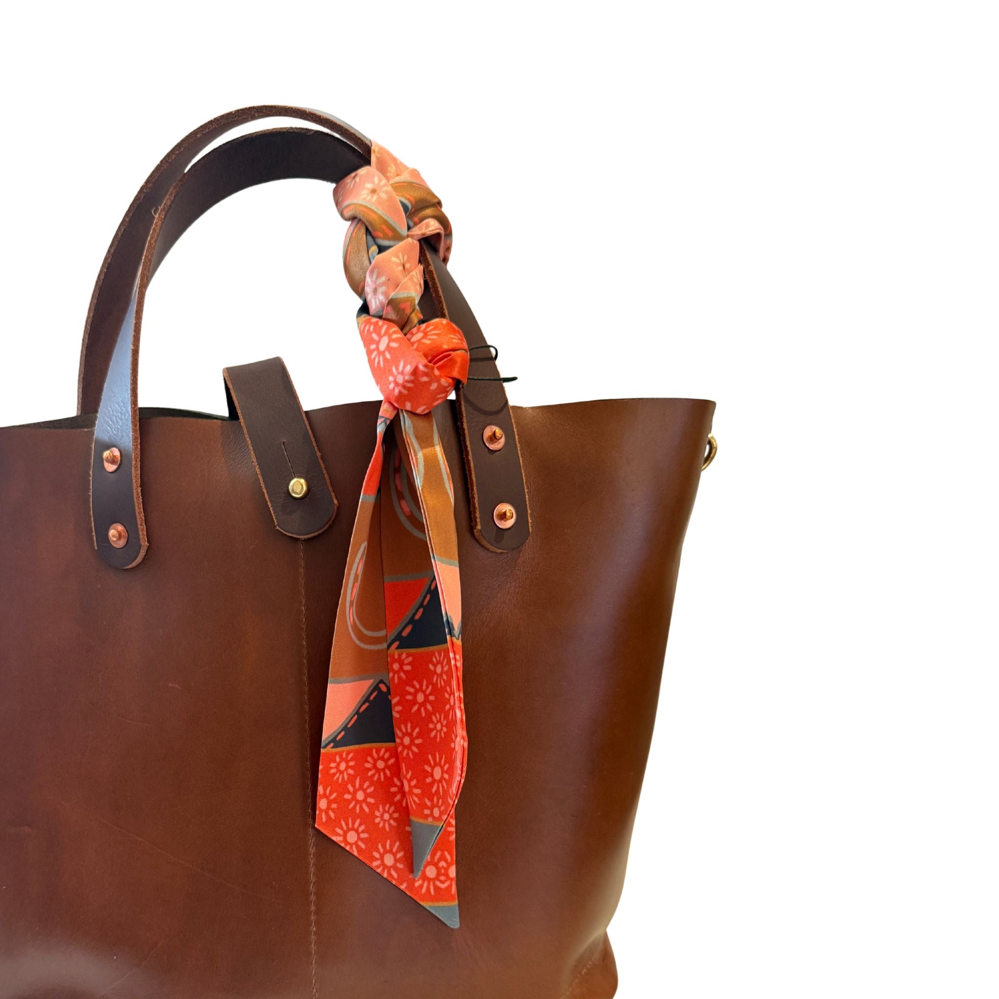 Brown leather tote bag with a colorful Twilly draped over the handle