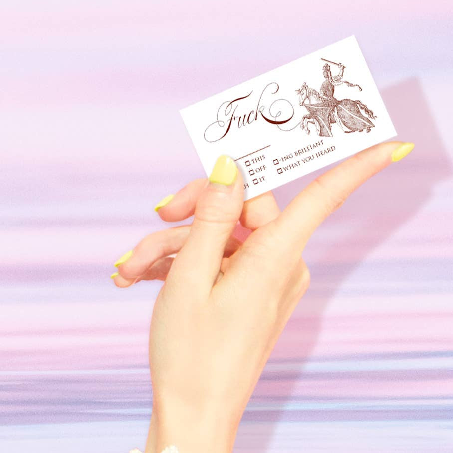 Hand holding a business card against a pastel gradient background