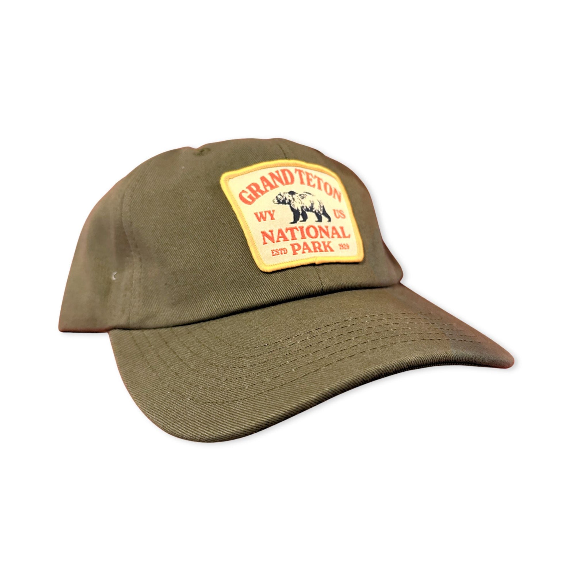 Army Green Dad hat with grand teton bear patch on it.