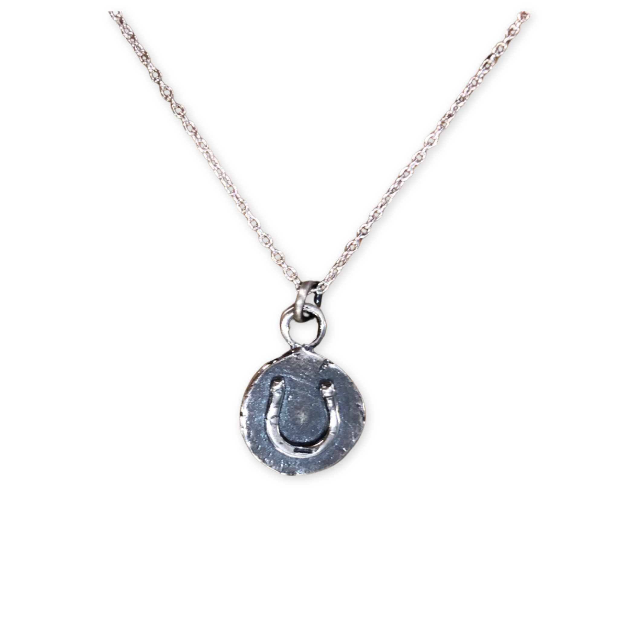 silver necklace with a round pendant with a stamped horseshoe