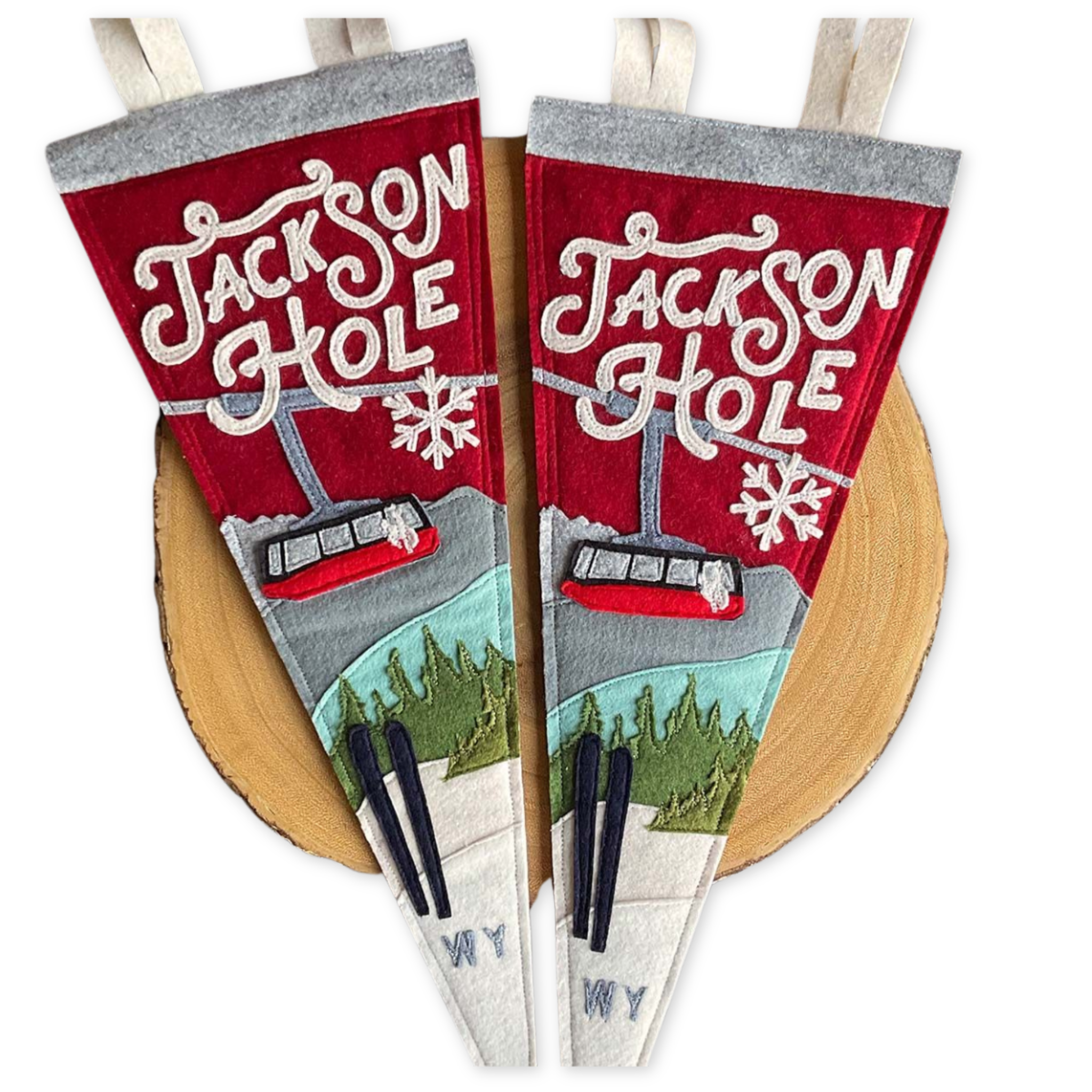 stitched felt pennant featuring jackson hole in the winter with the tram and a pair of skis