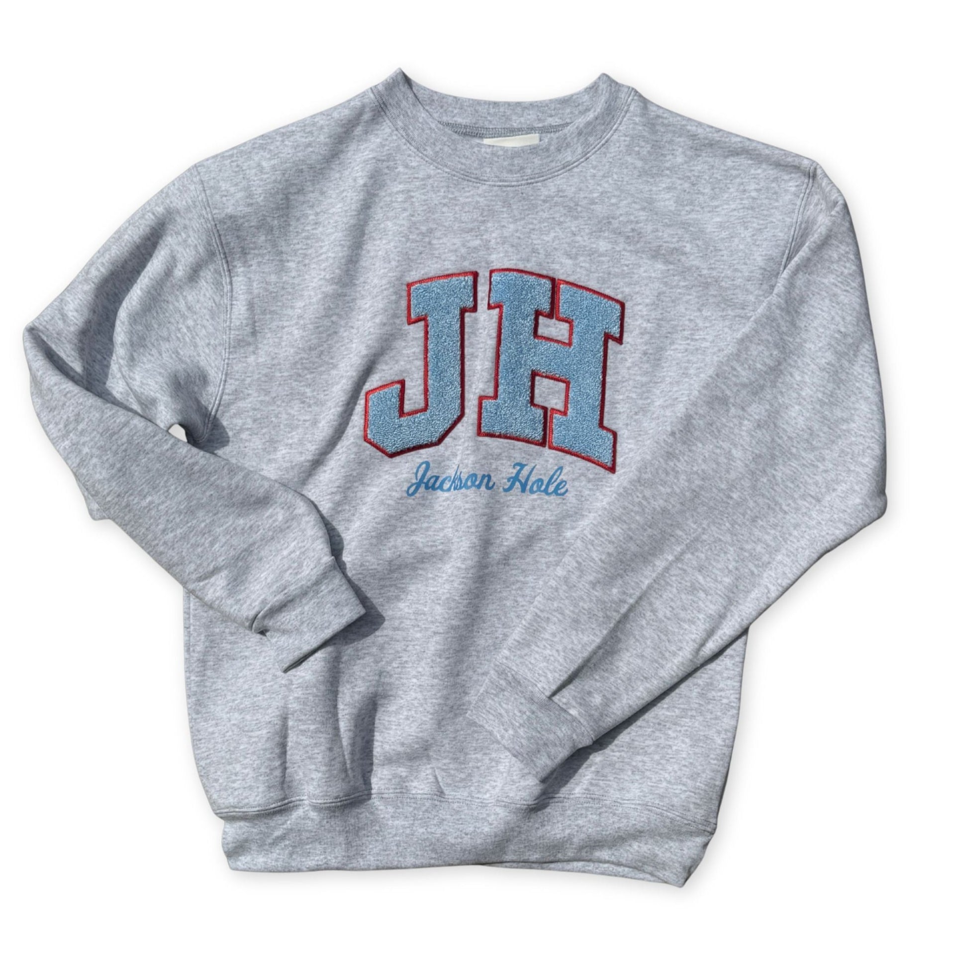 Gray sweatshirt with 'JH' and 'Jackson Hole' text
