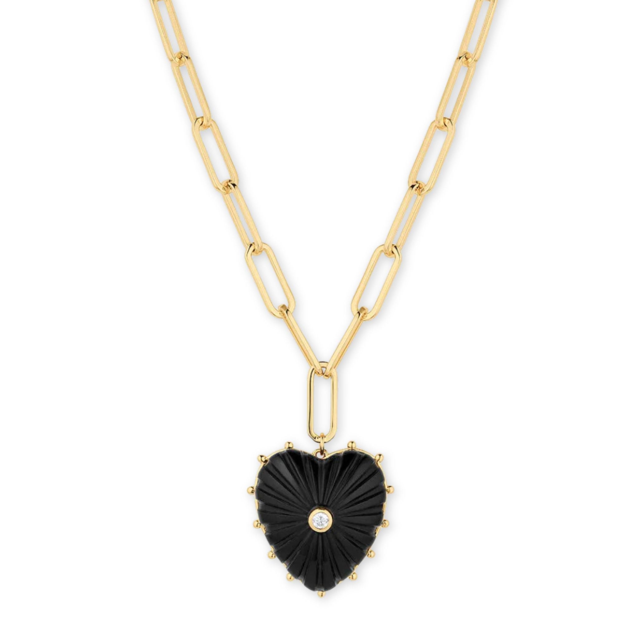 Gold necklace with a black heart-shaped pendant on a white background