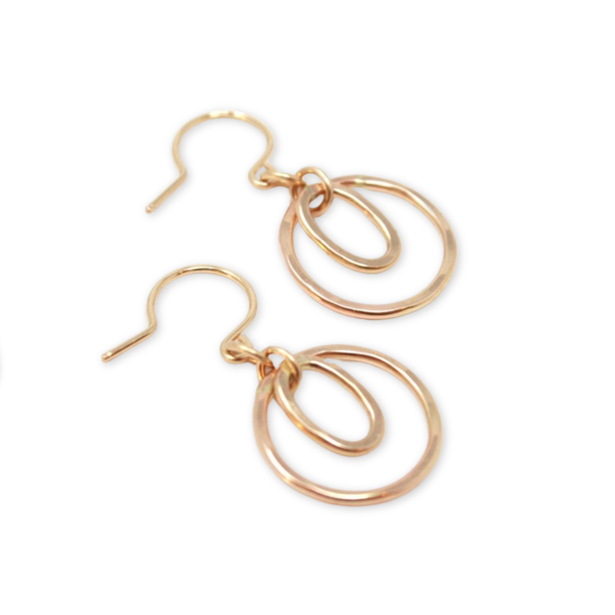 hand forged circle and oval pendants hanging from ear wire