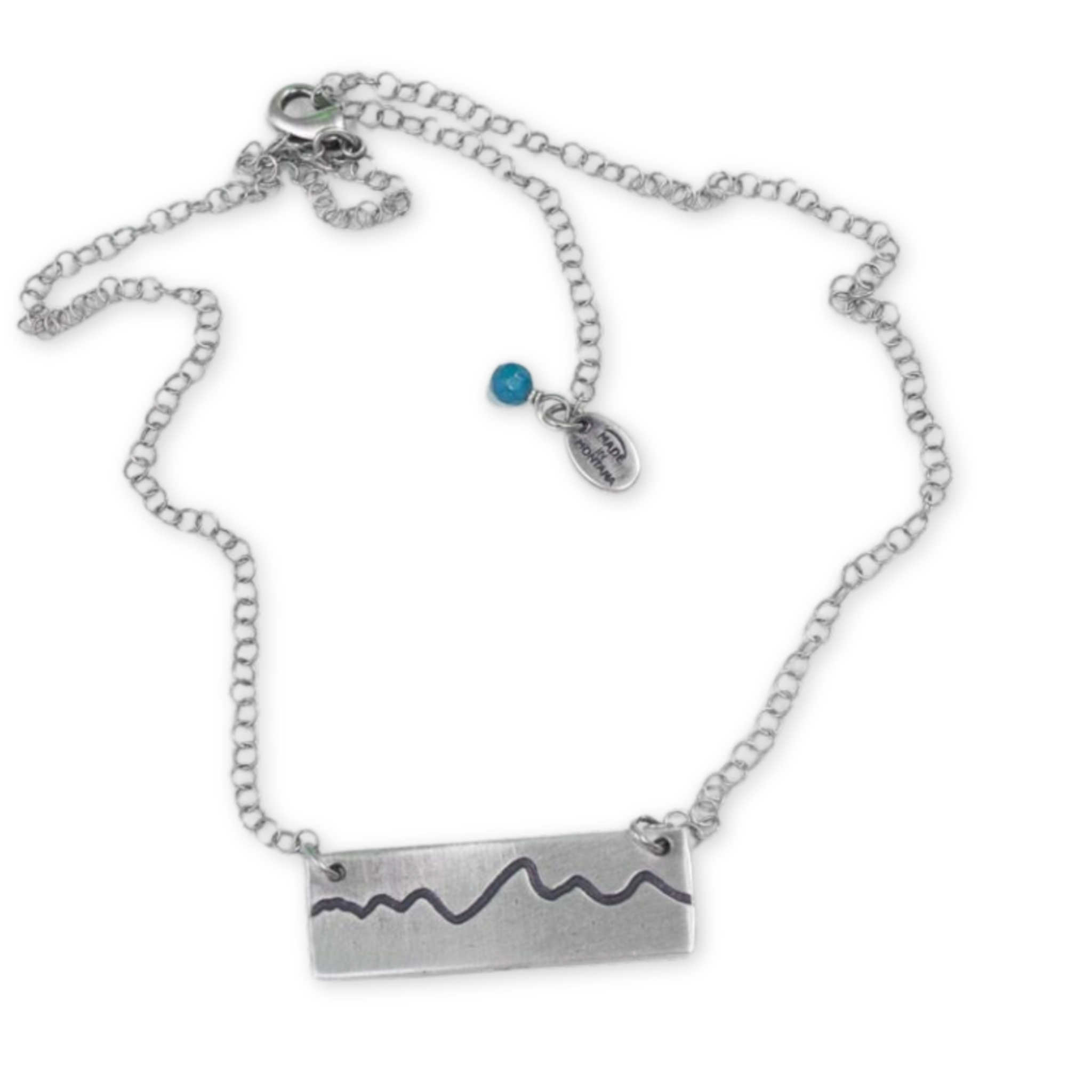 silver necklace with a rectangle pendant with the teton mountain range outline