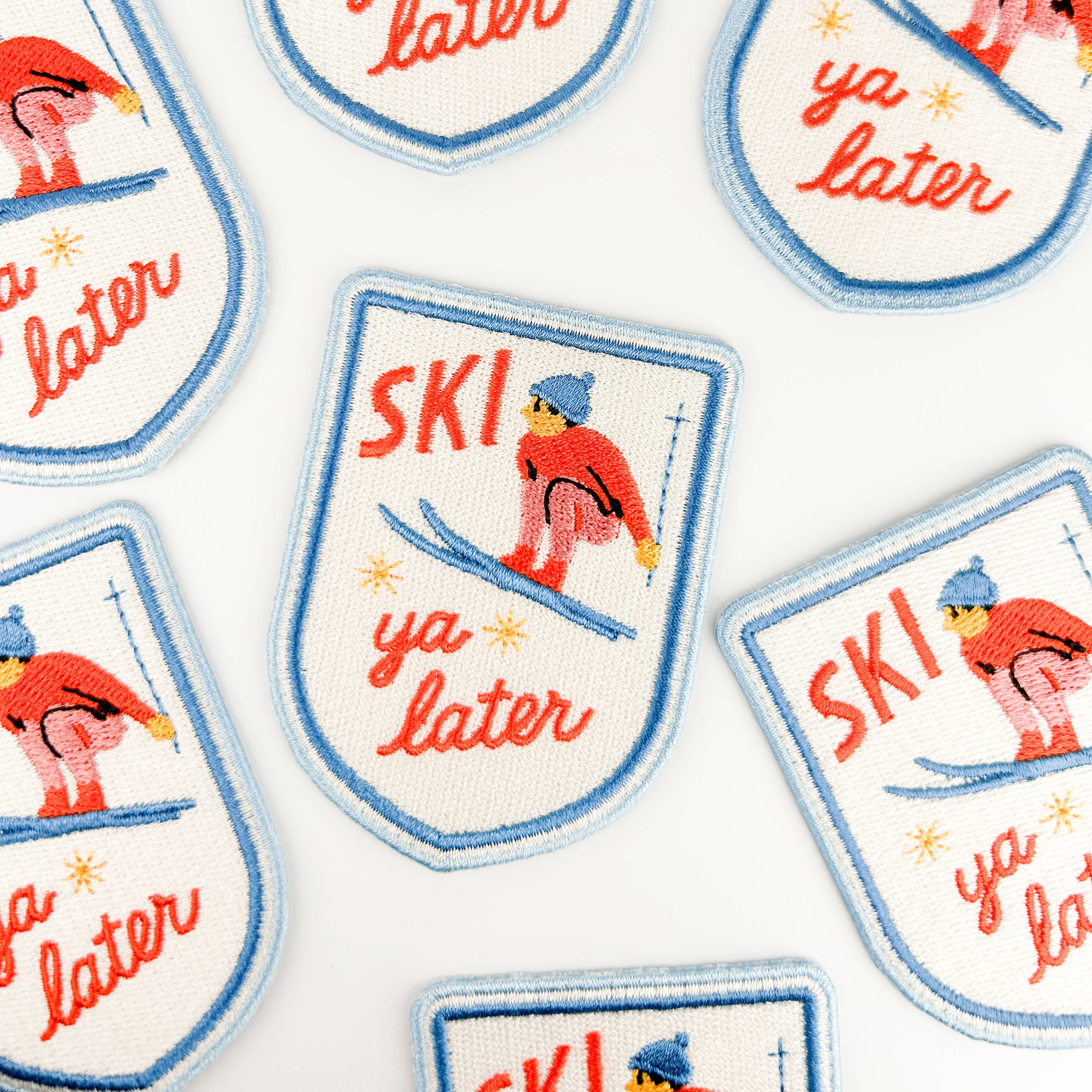 Embroidered iron on patch with a skier and 'Ski ya later' text.