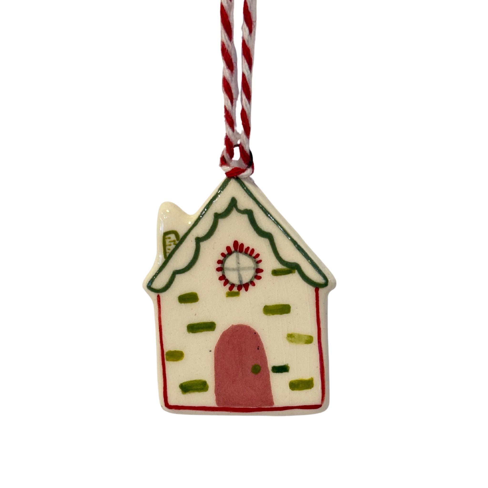 Decorative gingerbread house ornament on a white background