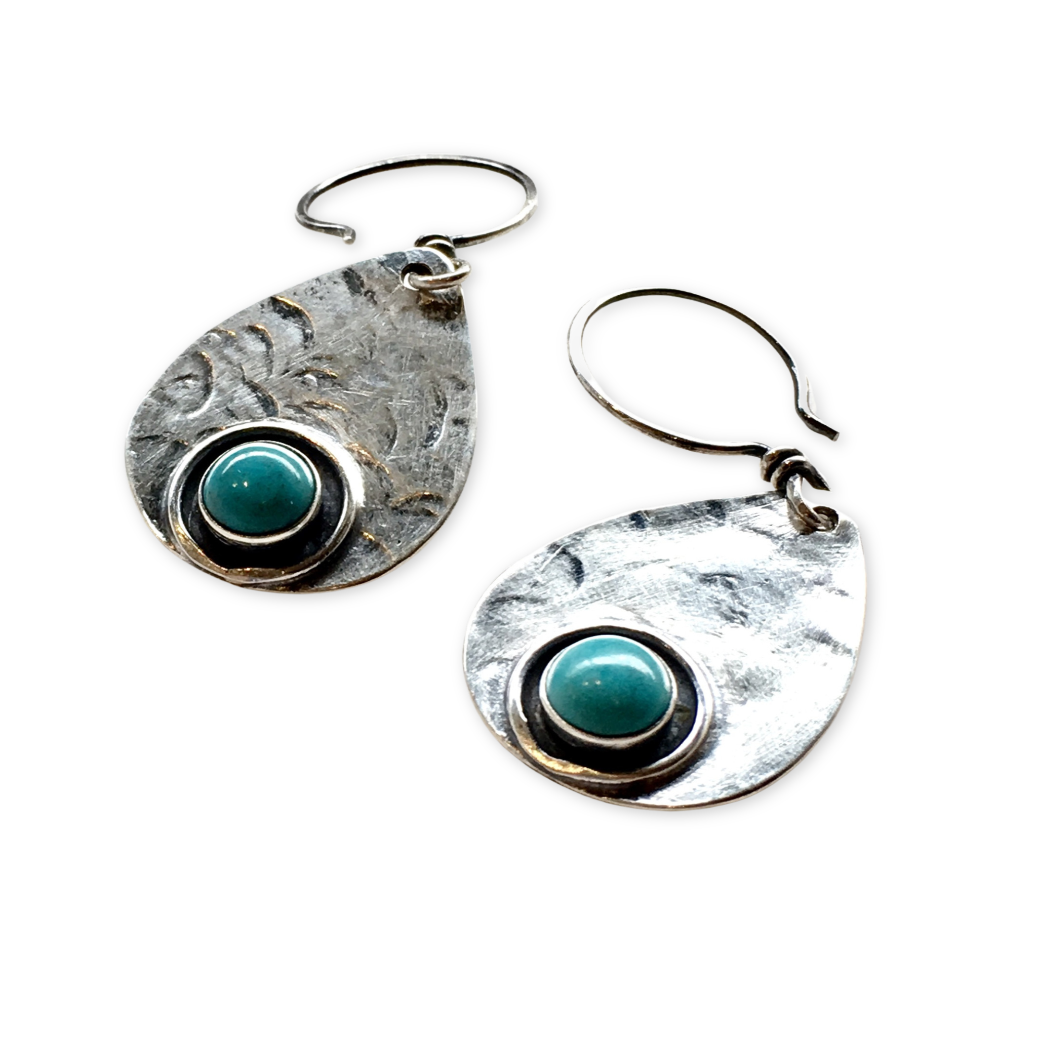 silver stamped teardrop shaped earrings with turquoise