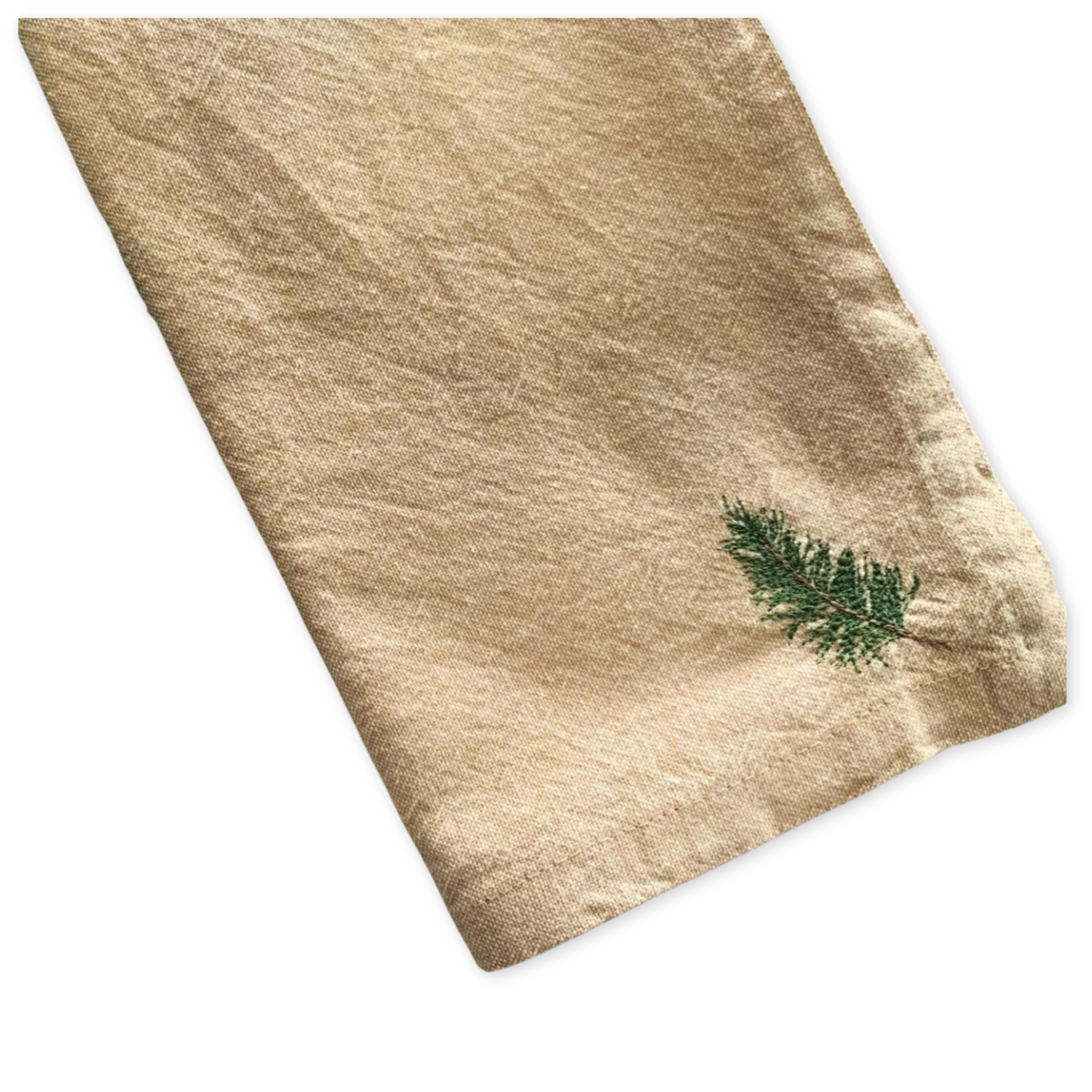 set of four cotton napkins with an embroidered pine tree branch in the bottom corner