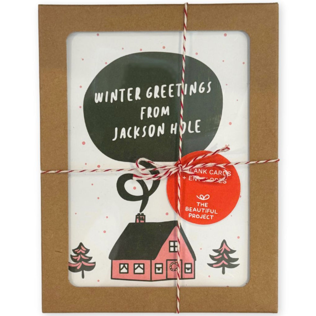 Winter Greetings from Jackson Hole Card Set, depicting a pink and green house in a winter setting with trees.
