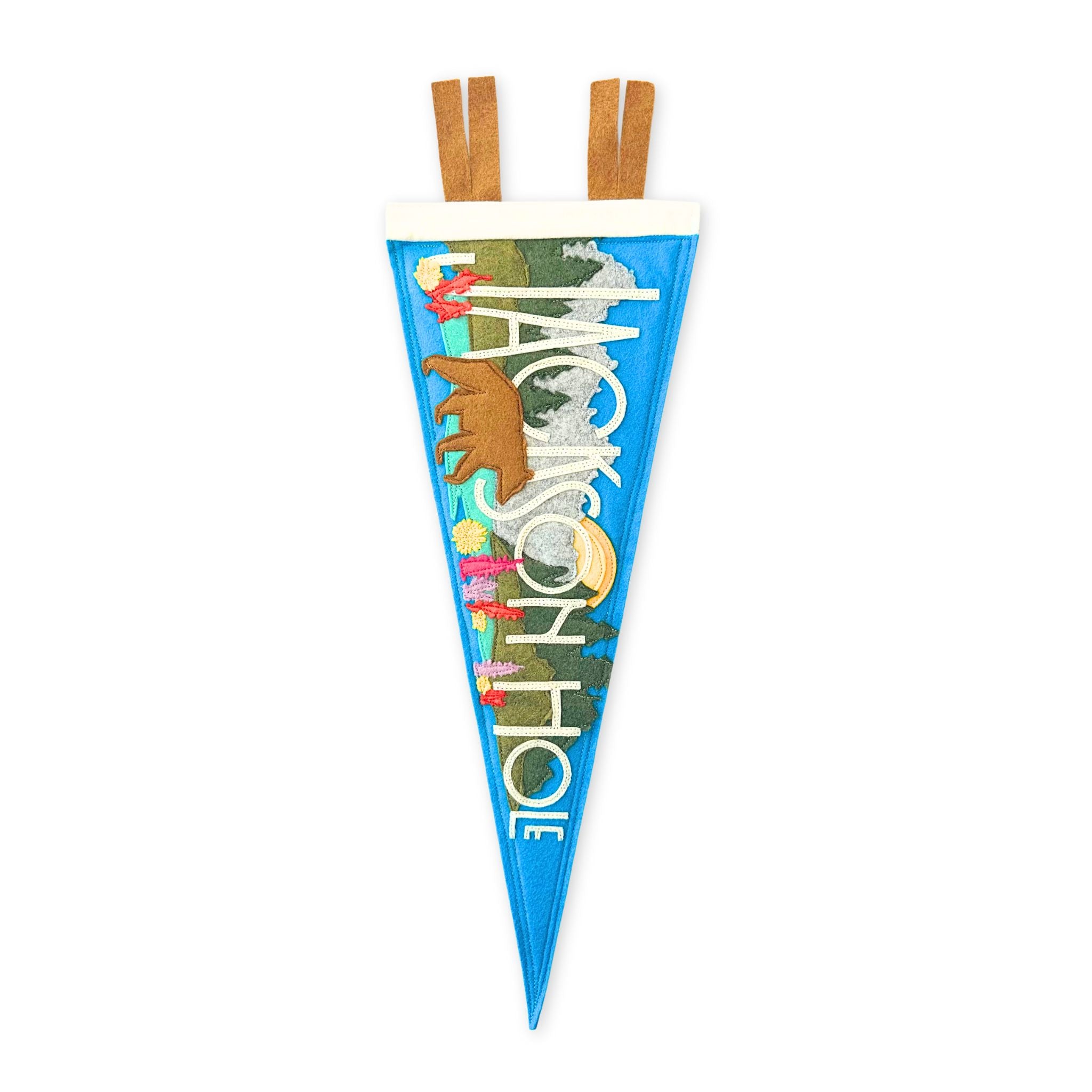 stitched felt pennant featuring the teton mountain range and a bear with wild flowers