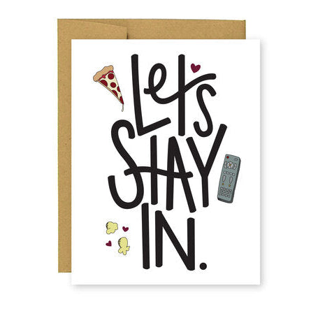 A greeting card with hand-lettered text 'LET'S STAY IN' on a white background, accompanied by small illustrations of a pizza, remote control, and hearts.