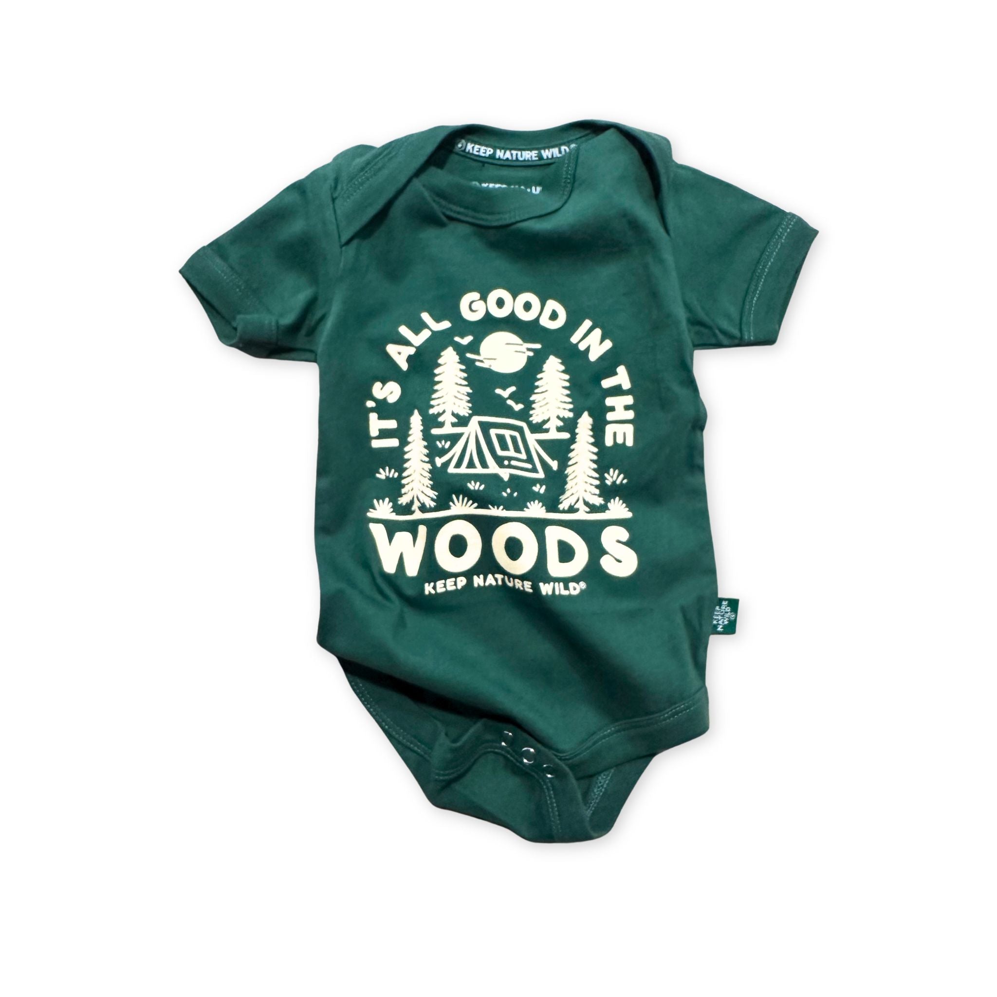 Green baby onesie with 'It's All Good in the Woods' text and graphic on a white background