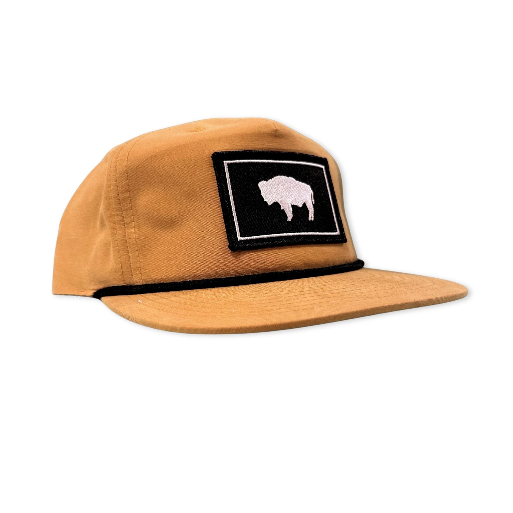 Tan Flat bill hat with the Wyoming black and white flag patch. 