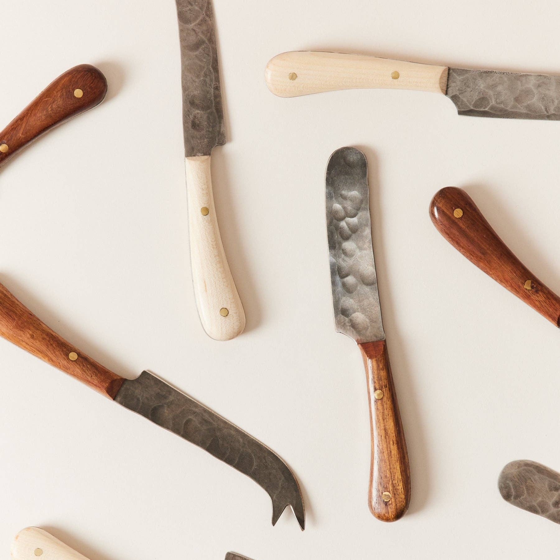 Set of knives with wooden handles on a white background