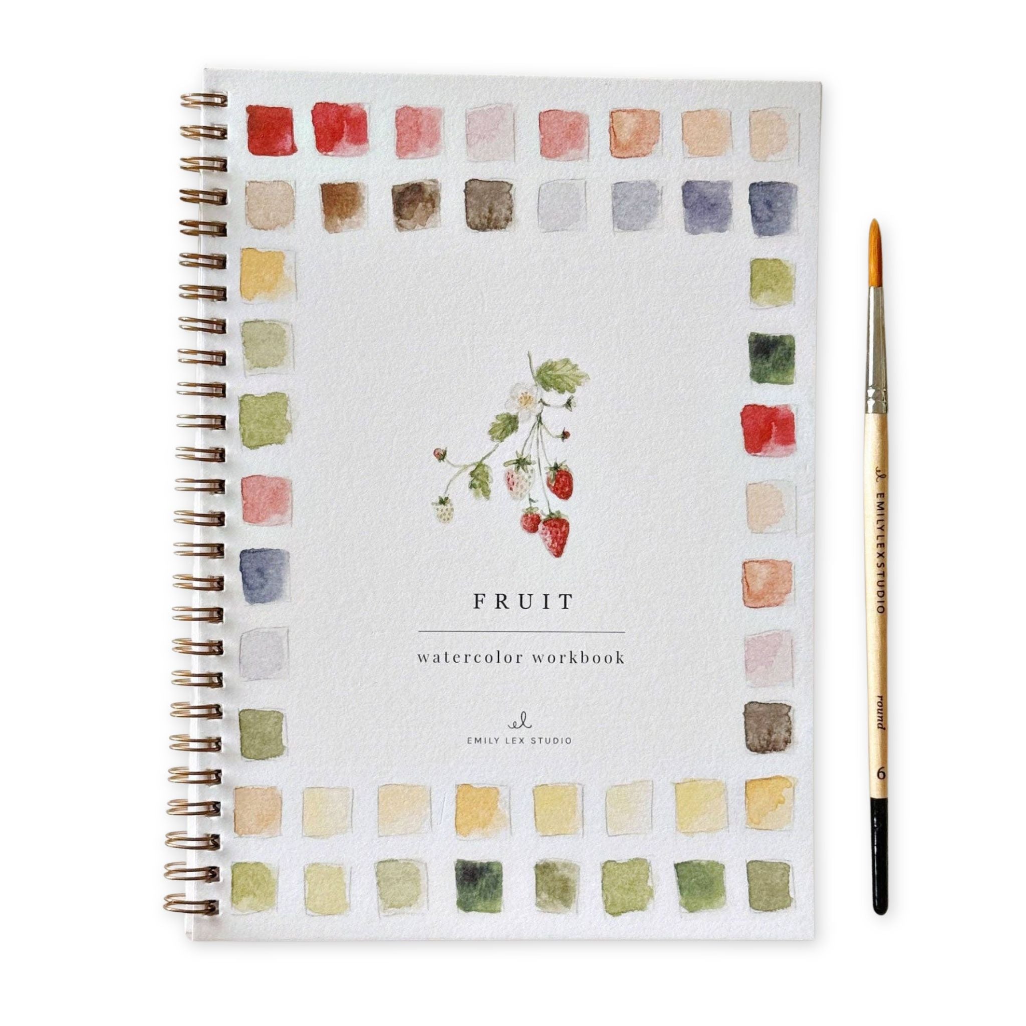 Watercolor workbook with color swatches and a brush on a white background