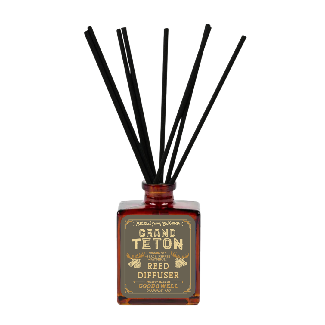 Reed diffuser with black sticks and 'Grand Teton' label on a white background