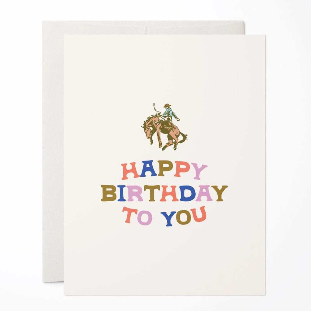Birthday card with colorful text and horse and rider illustration on a white background