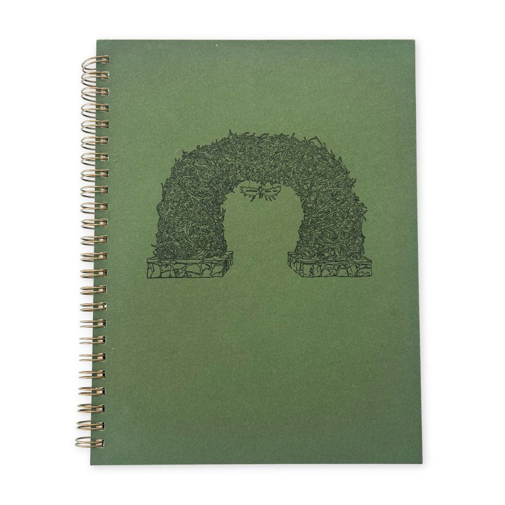 A green spiral journal with the Jackson Hole Antler Arch depicted on it. 