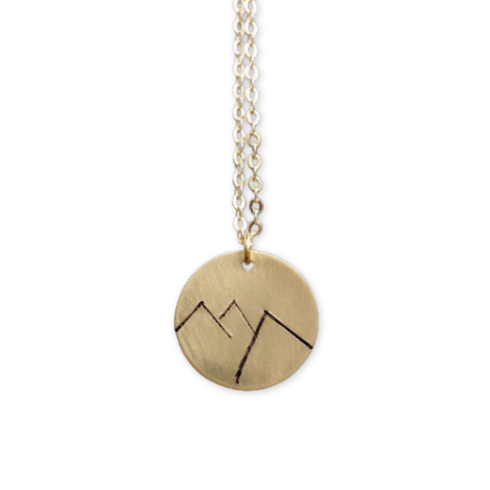 gold pendant with mountains on it