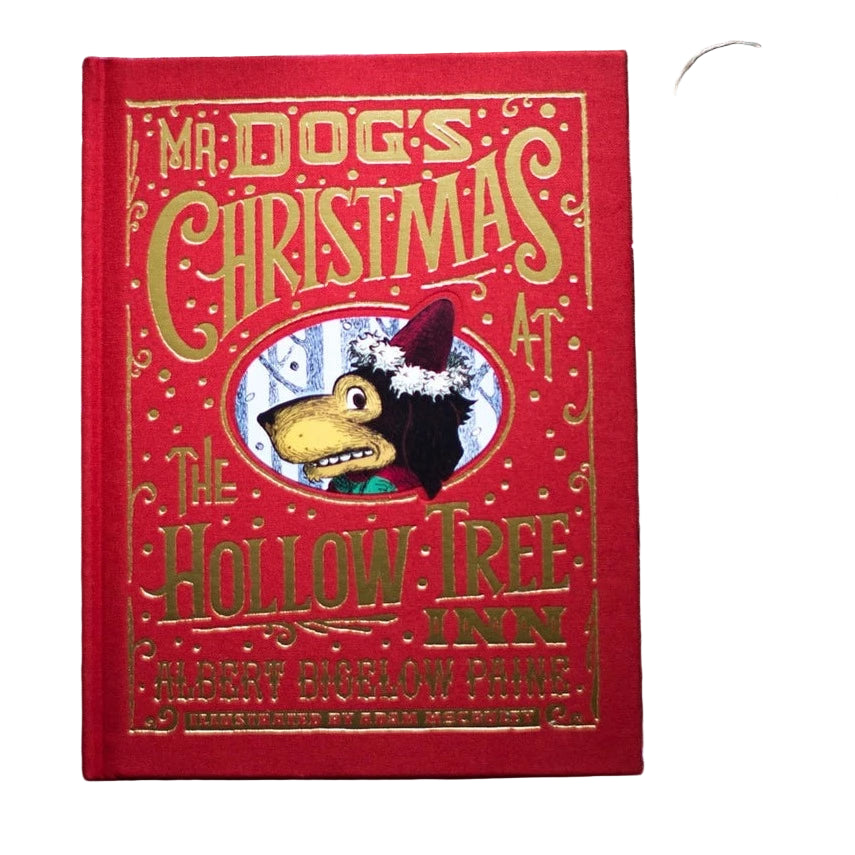 A hardcover edition of the book 'Mr. Dog's Christmas at the Hollow Tree Inn' with red linen binding and gold foil details, displayed on a festive background with holiday decorations.