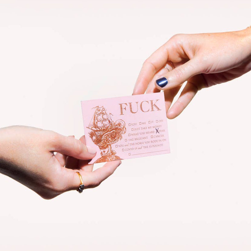 Two hands exchanging a pink card with text on a white background