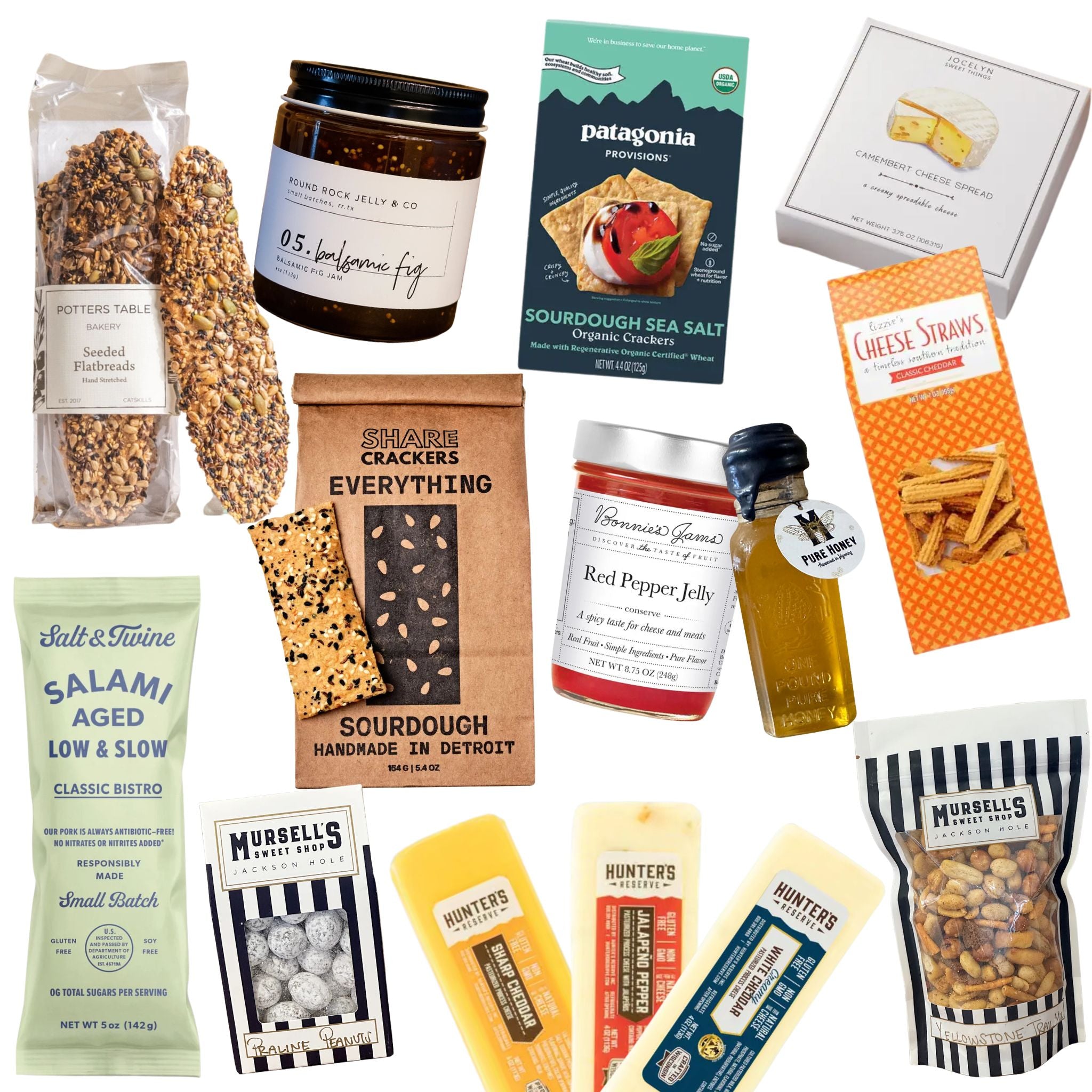 Assorted gourmet food items including crackers, jams, and snacks on a white background