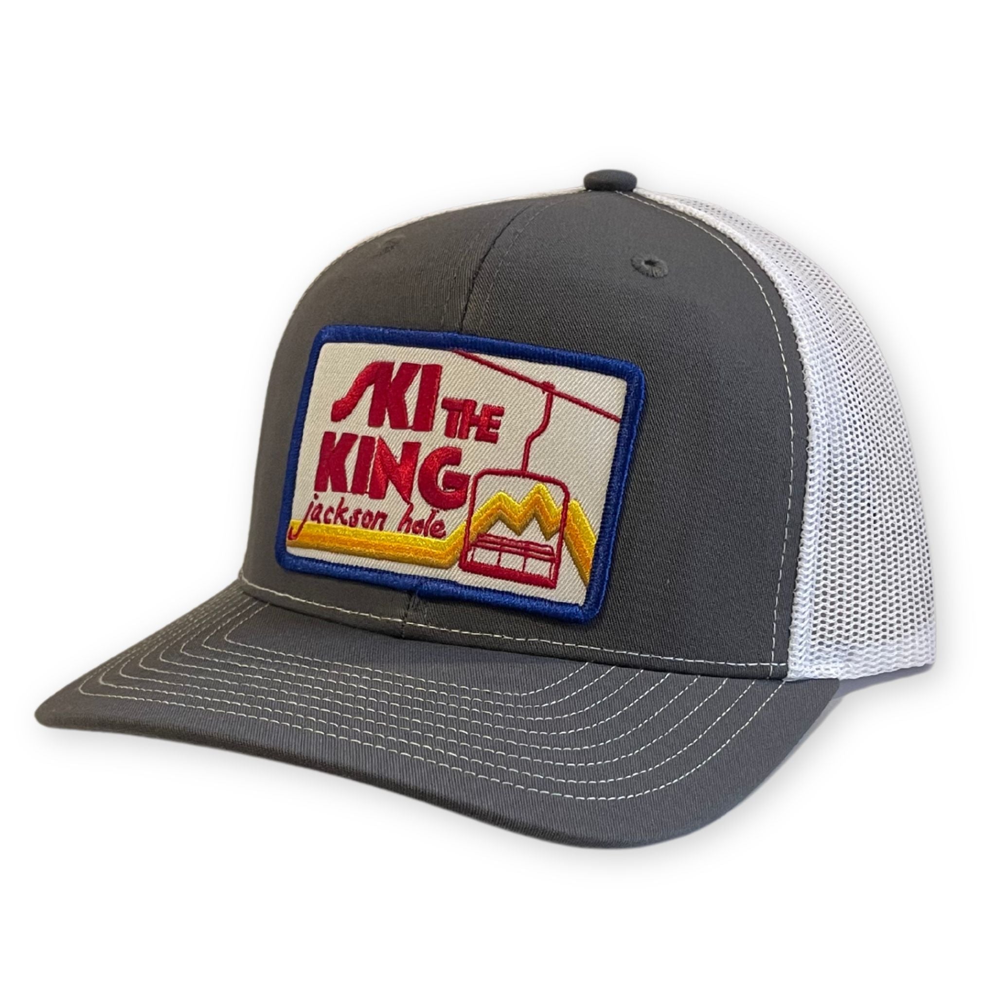 Gray Trucker Hat with White Mesh Back and a Ski the King Jackson Hole Patch 