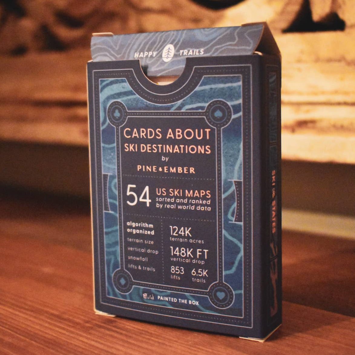 Cardboard box with text about ski destinations on a wooden surface