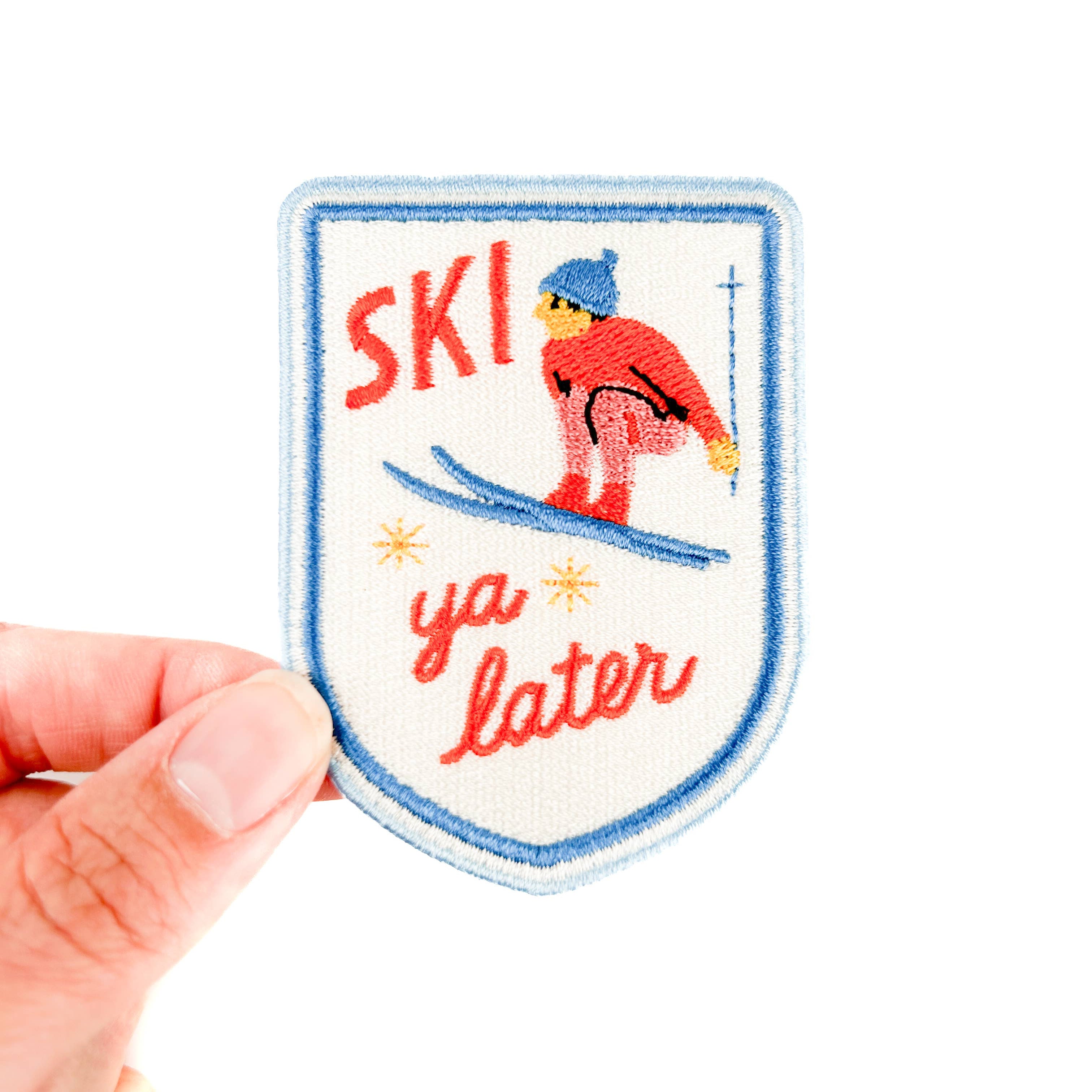 Embroidered iron on patch with a skier and 'Ski ya later' text. 