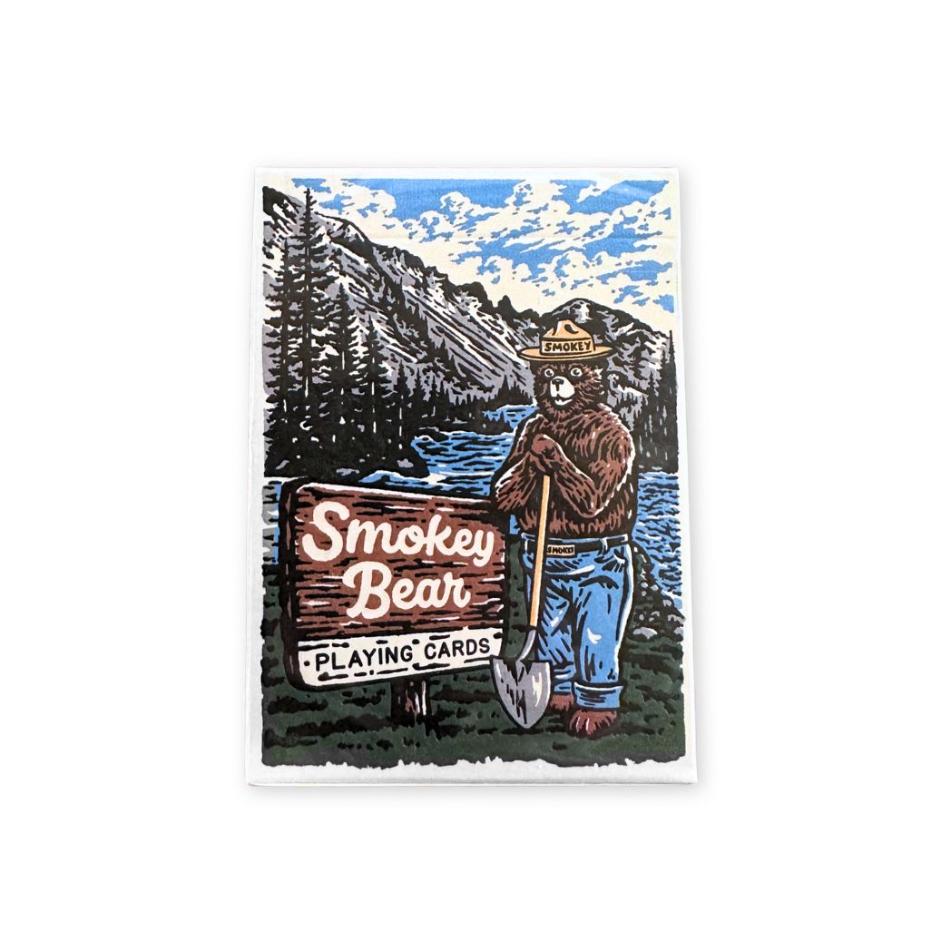 Smokey Bear playing cards packaging with bear holding a shovel and mountains in the background