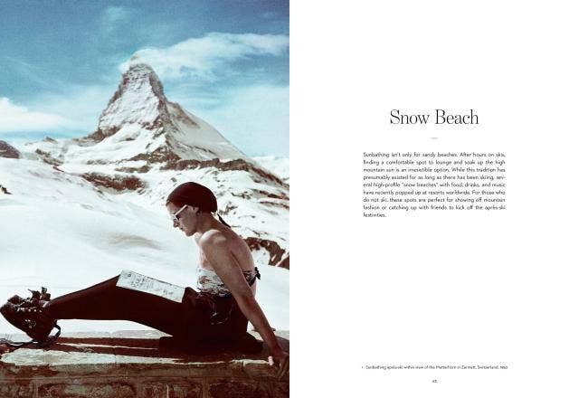 Person sitting on a bench with a snowy mountain and blue sky in the background