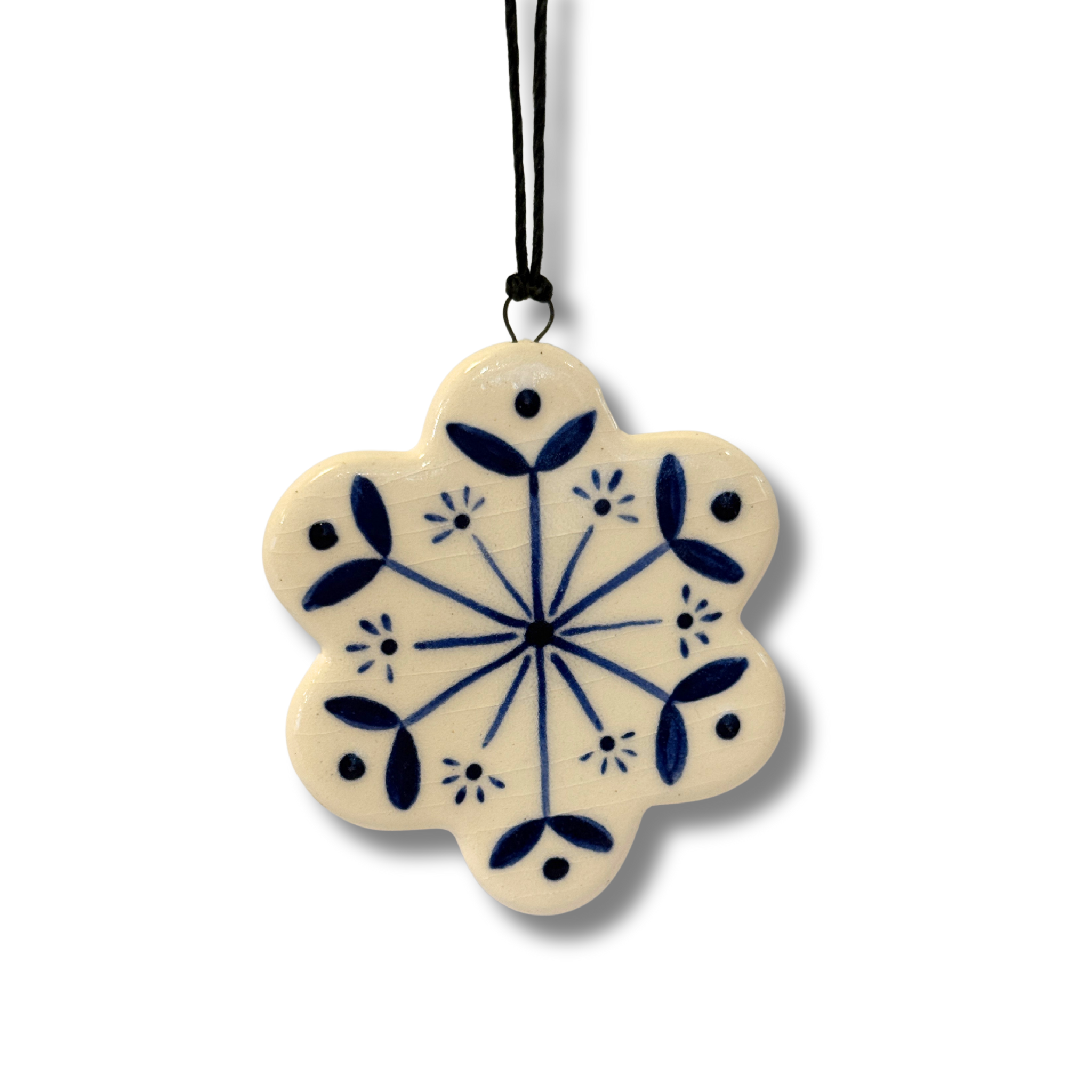 Decorative snowflake-shaped pendant with blue floral patterns on a white background