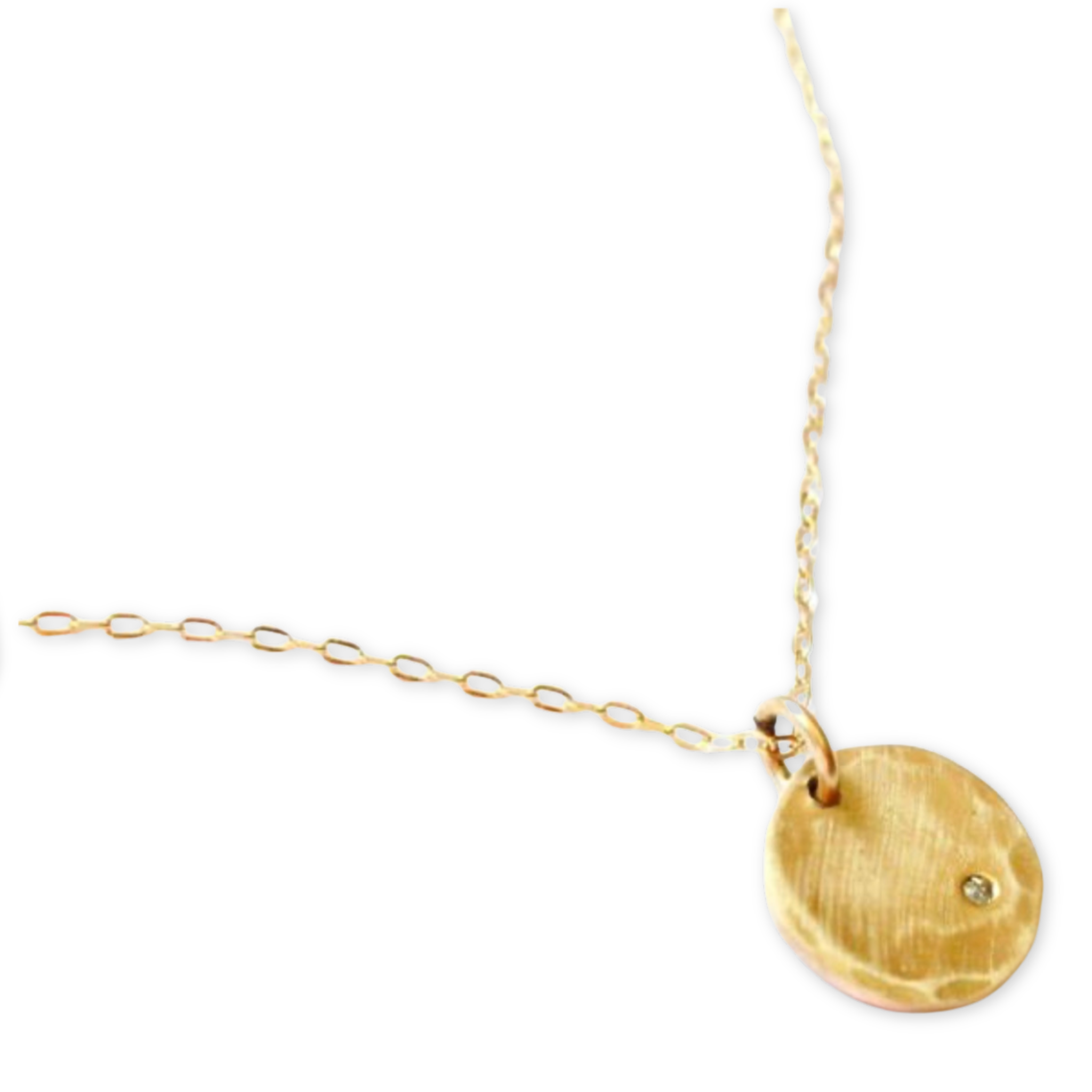 hammered round disc pendant with a tiny cubic zirconia and hanging from a delicate necklace chain