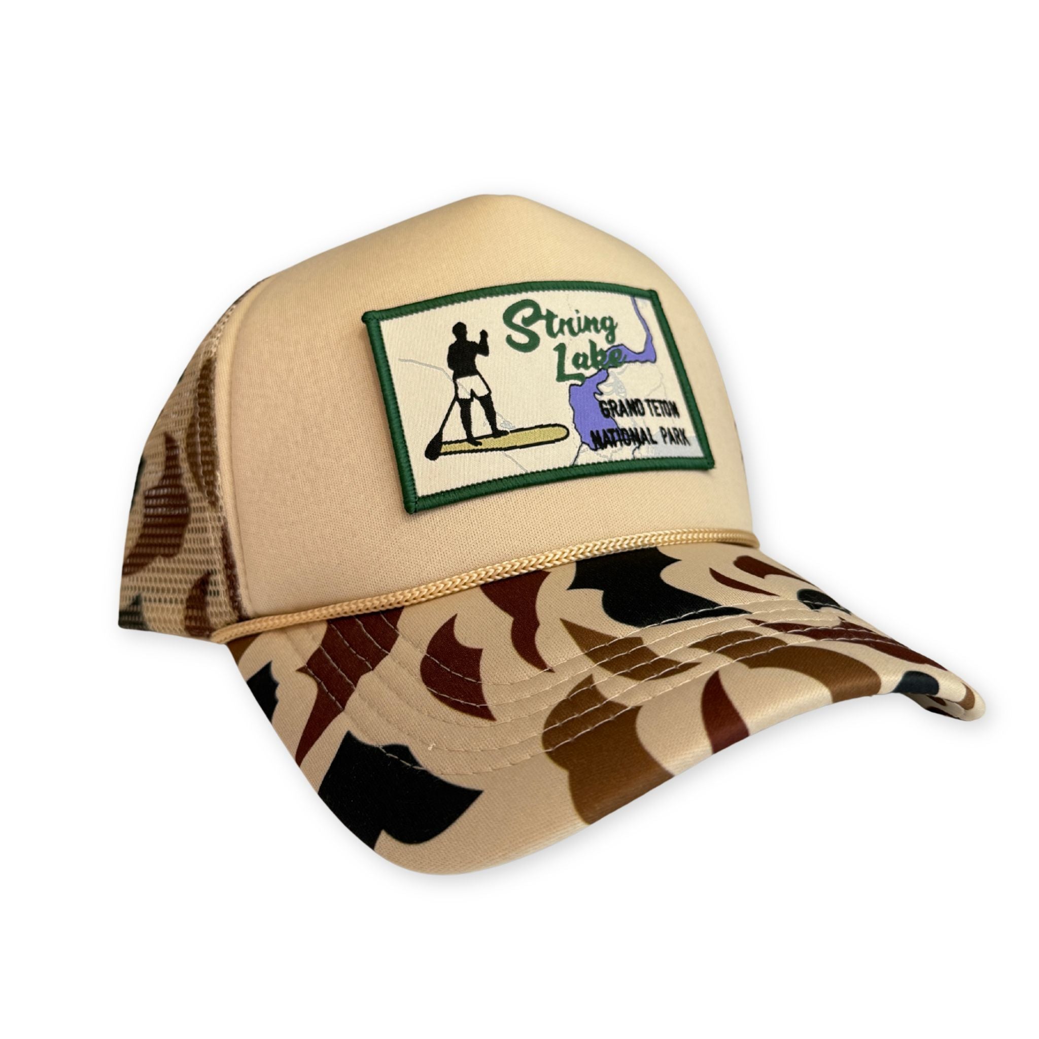 Beige and camouflage cap with a logo on a white background