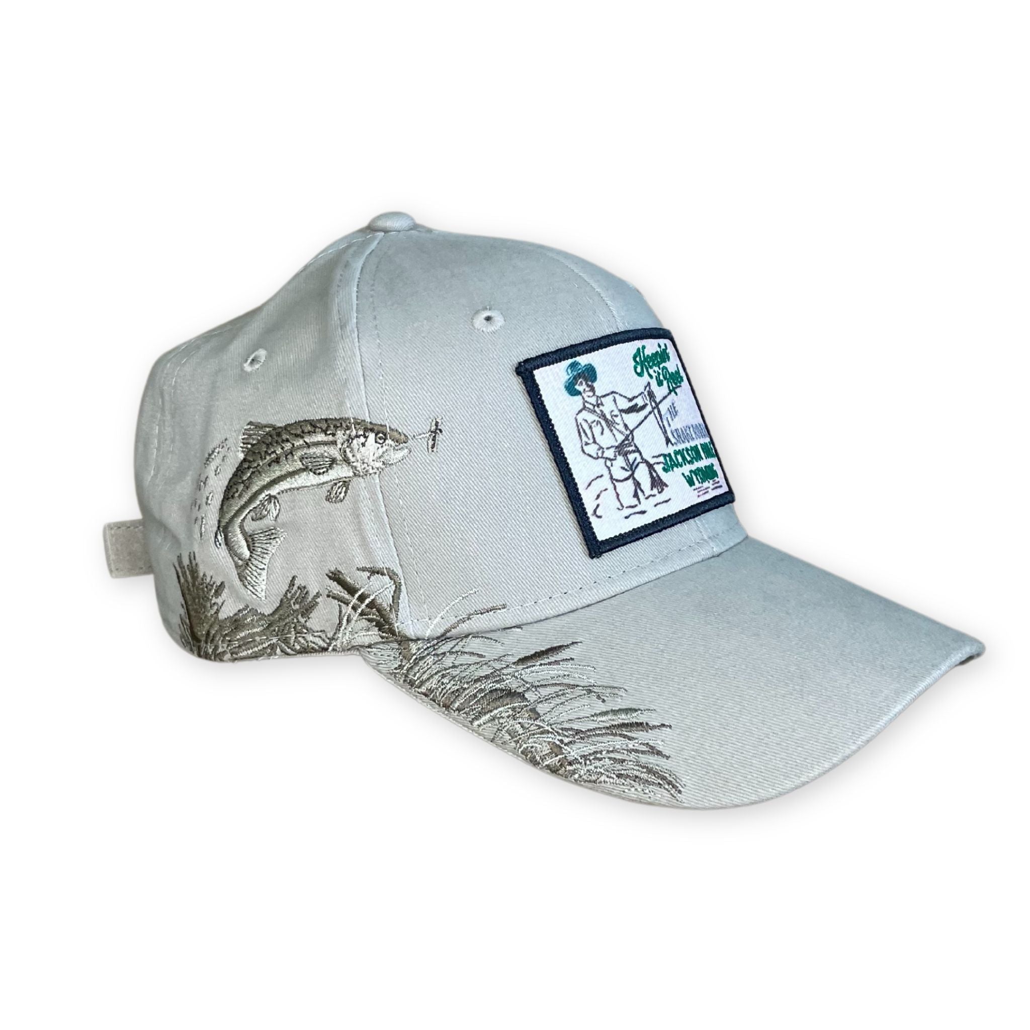 Tan hat with embroidered fish design on the side. patch on the front. 