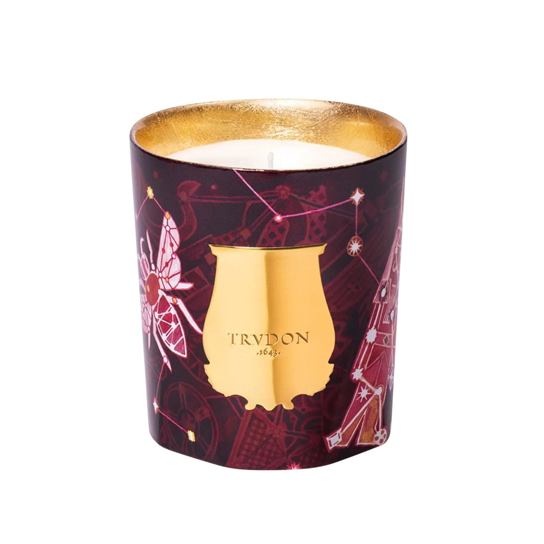 Candle in a decorative container with gold lid and star constellations on a white background
