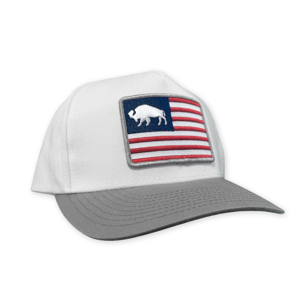 White and grey two tone hat, with an American Flag Patch that includes a bison instead of stars.