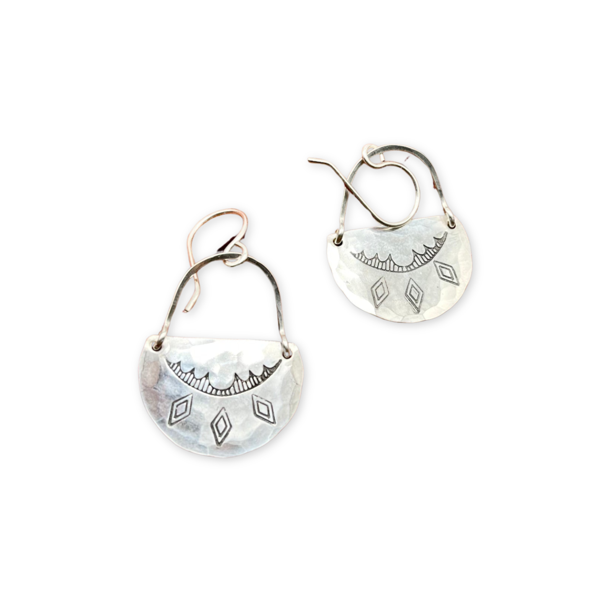 earrings featuring hand stamped pendants hanging from hand forged arches
