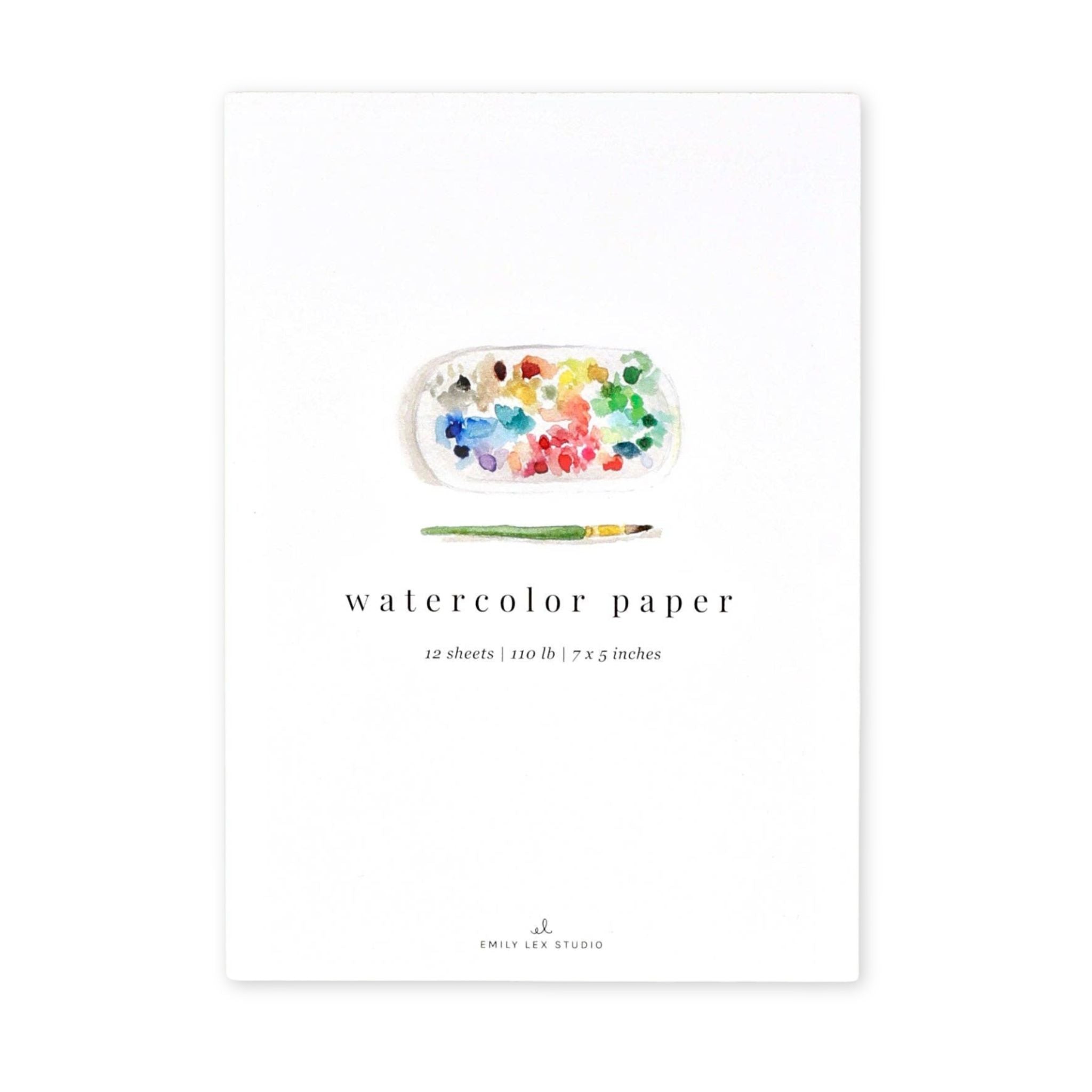 Watercolor paper with a paint palette and brush on a white background
