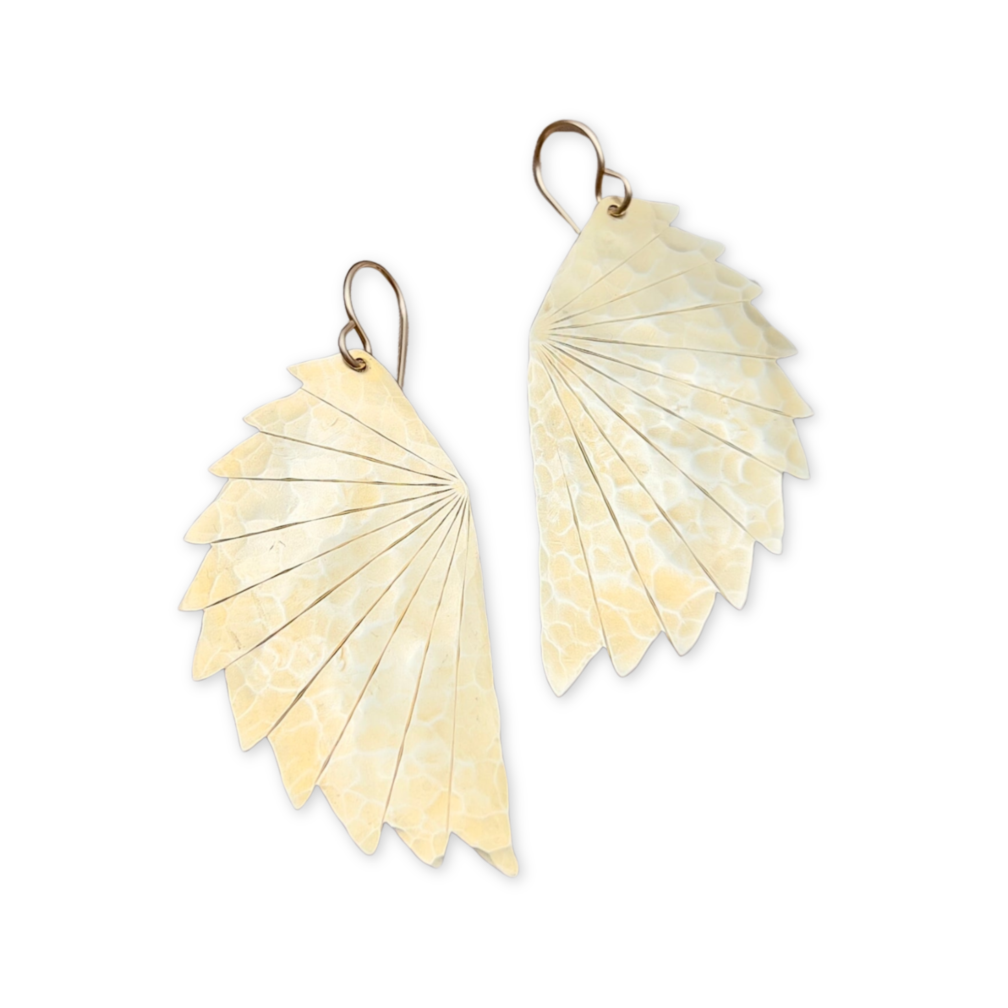 a pair of earrings in the shape of wings