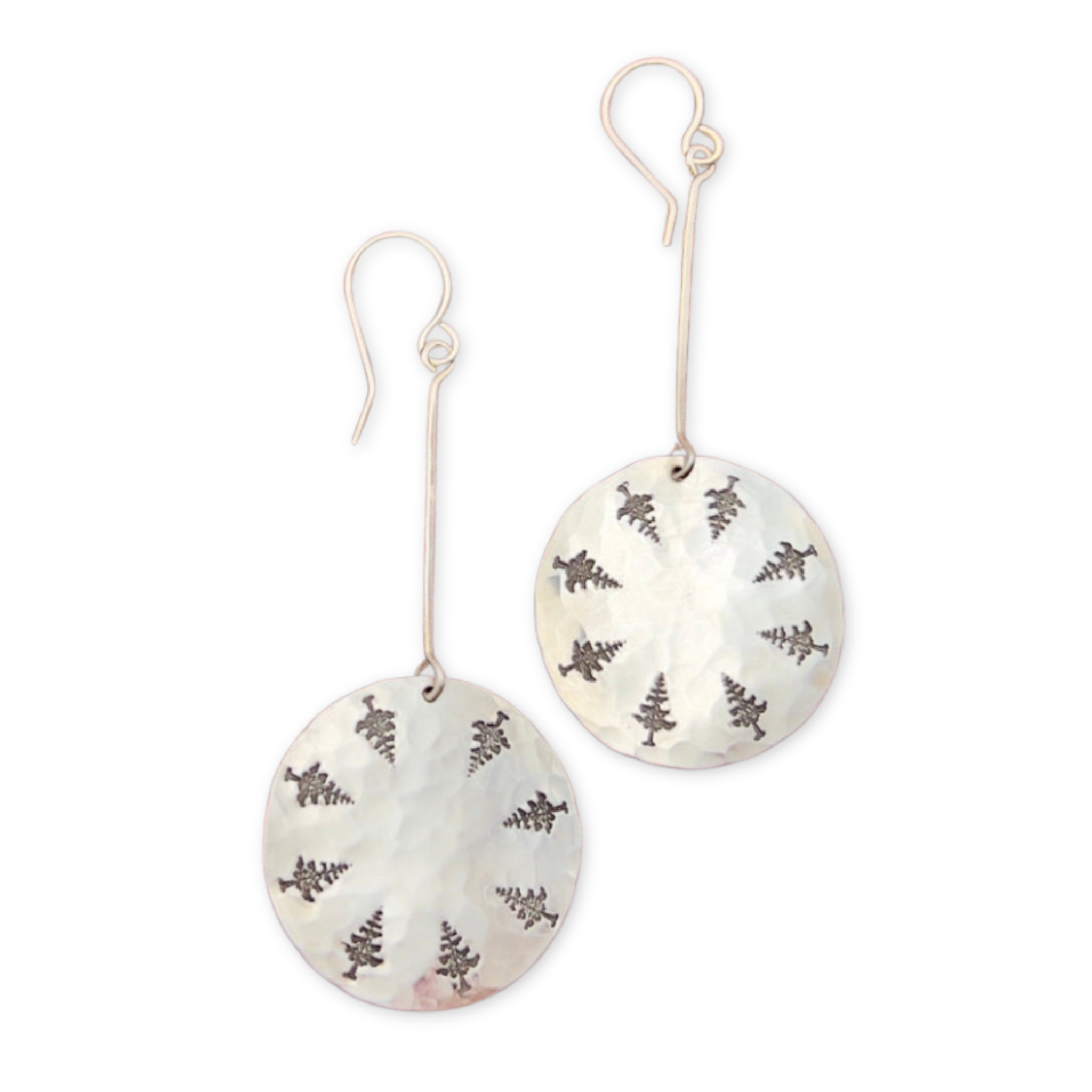 earrings featuring pine trees stamped on round discs hanging from sterling wire 