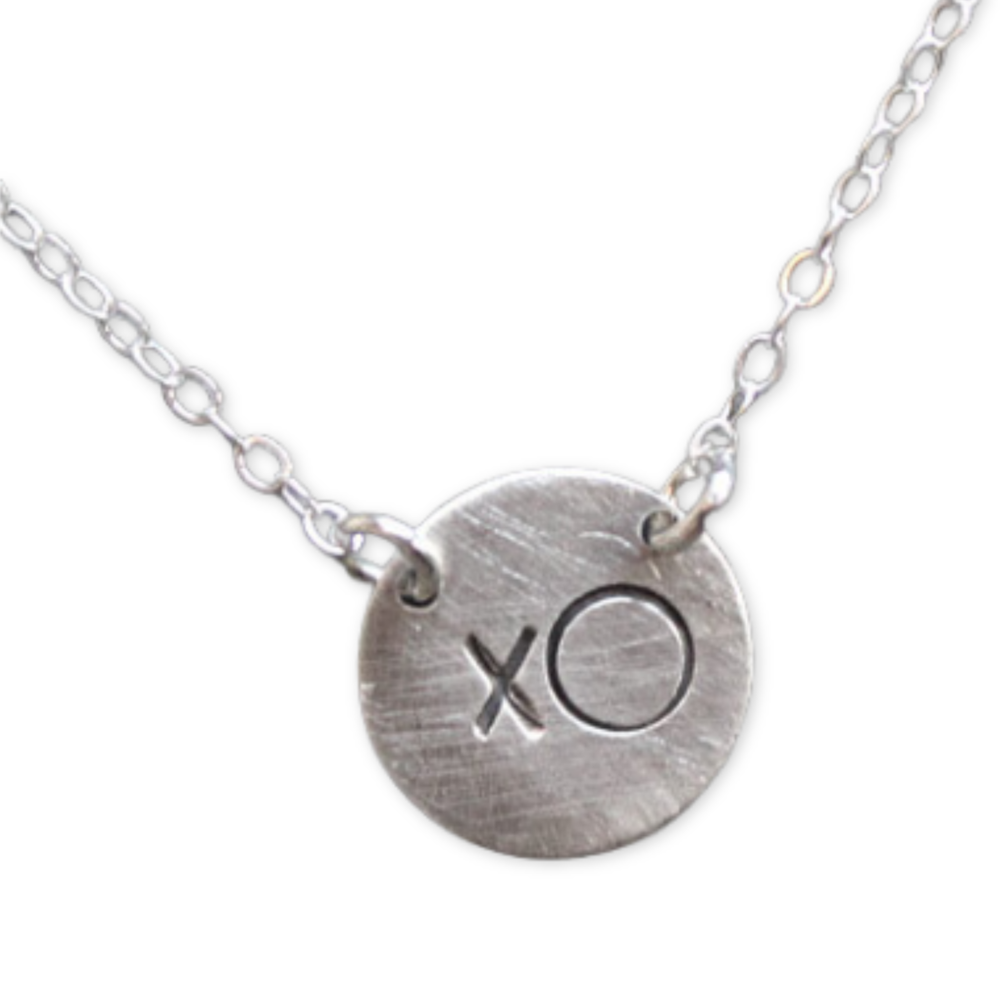 round disc pendant with xo design on a silver chain